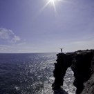 Hiker atop the Holei Sea Arch